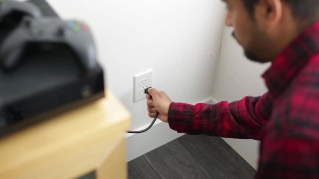 Man Unplugging Electronics