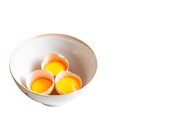 Separated egg yolk in bowl on white background