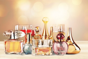 Aromatic Perfume bottles on white wooden desk at wooden background