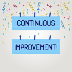 Text sign showing Continuous Improvement. Business photo text involves small consistent improvements over time Two Color Blank Strip Size Lined Paper Sheet Hanging Using Blue Clothespin