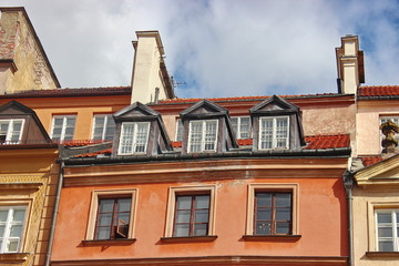 red-tiled roof with skylights in the old town. protection of the house from precipitation. beautiful decor of the old building
