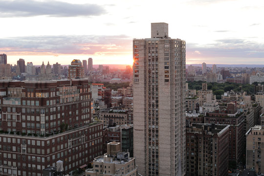View of cityscape against cloudy sky