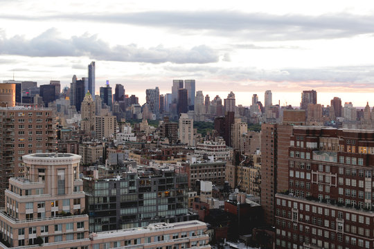 View of cityscape against cloudy sky