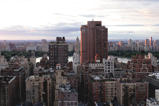 View of cityscape against cloudy sky