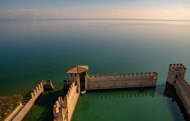 High angle view of the medieval port fortification of the Scaligero castle (13th century) on the shore of Lake Garda, Sirmione, Lombardy, Italy