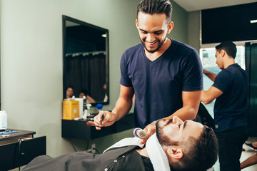 Client during beard and hair grooming in barber shop