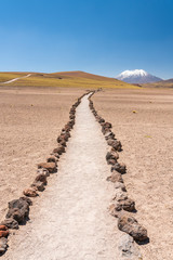 Path in between the rocks and sand in the dry Atacama desert inside the Andes Altiplano an amazing...