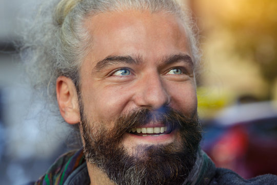 Close up of smiling man with gray eyes