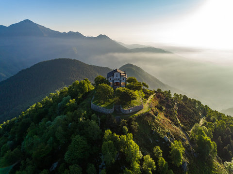 View of house on mountain top against cloudy sky