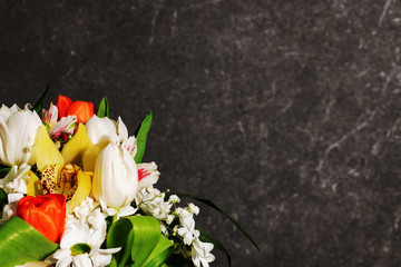 Bouquet of bright fresh flowers with marble in the background