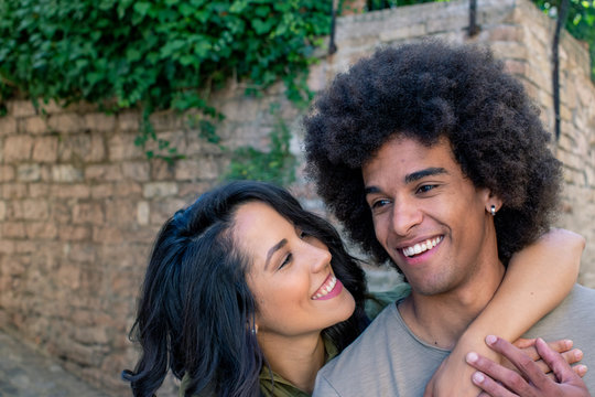 Smiling young couple embracing outdoors