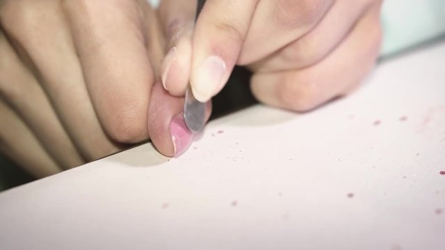 Manicure. Close-up. Remove old nail polish. Removal of a red varnish from a nail. Preparation of a nail for painting by a new varnish