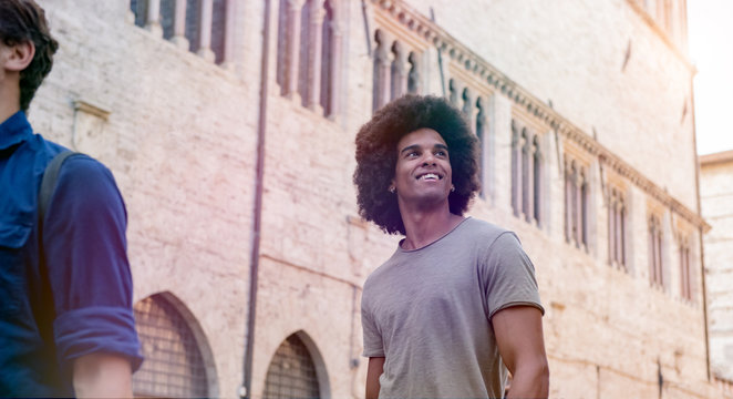 Smiling afro young man walking outdoors