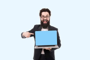 cheerful smiling bearded businessman pointing on blank laptop computer screen