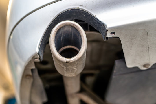 The exhaust system in the car seen from below, the car is on the lift in the car workshop.