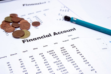 Financial accounting, Image a plurality of numbers on paper and calculator, Numbers on paper, a pen and a calculator, coins.