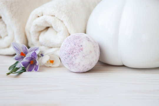 Saffron flowers, aromatic sea salt, vase and towels. Concept for spa, beauty and health salons. Close up photo on white wooden background, selective focus