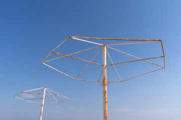 Rusty umbrella supports in the resort town in the spring in the off-season. 