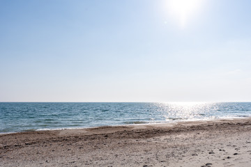 Sand-shell seashore in the afternoon during sunny weather in summer