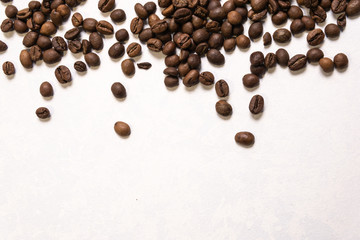 Roasted coffee beans in bulk on a light blue background. dark cofee roasted grain flavor aroma cafe, natural coffe shop background, top view from above, copy space
