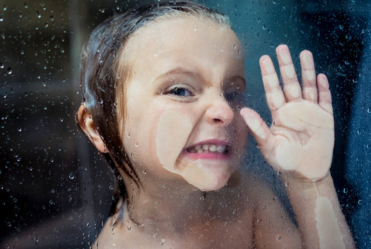 Girl with hand pressed against shower glass