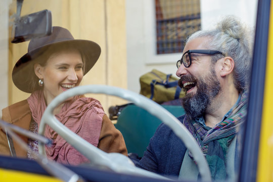 Smiling couple sitting in car