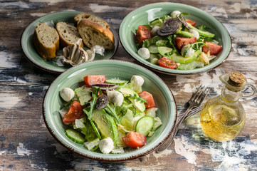 Vegetable salad. Delicious salad with avocado, cherry tomatoes, arugula and mozzarella cheese. Tasty and healthy food