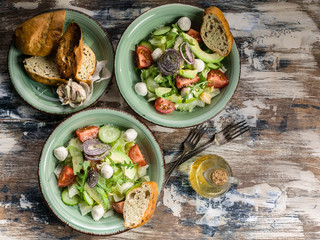Italian vegetable salad with avocado, cherry tomatoes, arugula and mozzarella cheese. Delicious and healthy food. Mediterranean Kitchen. Top view