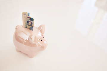 Piggy bank on an white table