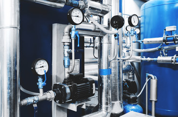 Water treatment pump and pipes with installed pressure gauges for pressure control. Expansion Tank...