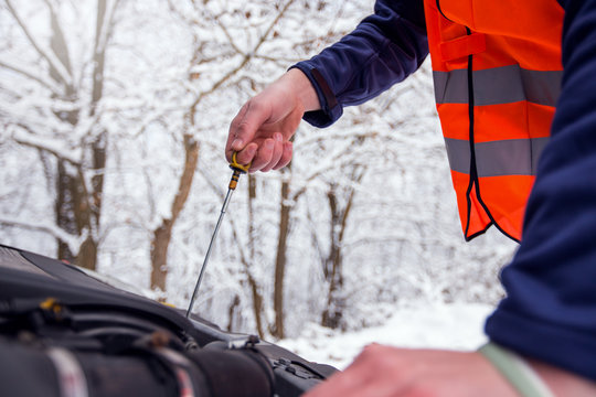 Check oil level in car engine - Powered by Adobe