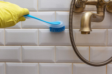 cleaning the tile in the shower room