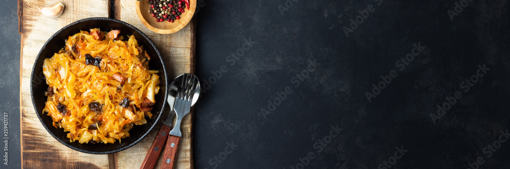 Wall mural traditional dish of polish cuisine - bigos from fresh cabbage, meat and prunes. top view with copy s