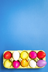 Easter eggs in a paper bag on trendy blue background. 2019. Easter card. Space for text. Happy easter.