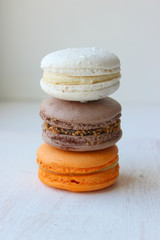 Colorful French or Italian macaroon stack cakes / Macaroon cakes. Assorted macaroon cakes stacked on top of each other on a light background. Copy space. Delicious dessert.