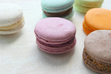 Colorful French or Italian macaroon stack cakes / Macaroon cakes. Assorted macaroon cakes stacked on top of each other on a light background. Copy space. Delicious dessert.