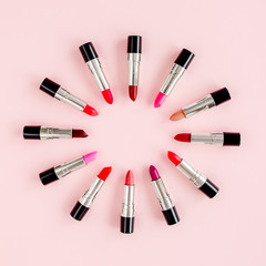 Set of color lipsticks on pink  background. Professional decorative cosmetics. Flat composition beauty, fashion. flat lay, top view