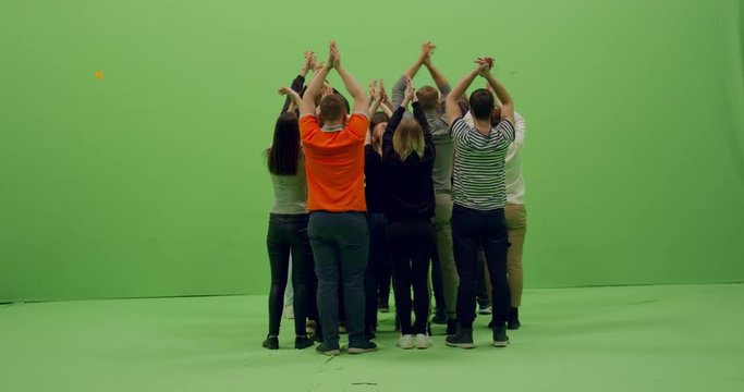 GREEN SCREEN CHROMA KEY Back view group of young people standing and clapping hands in the air. 4K UHD ProRes 4444