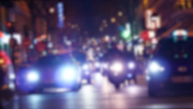 Defocused blur view of cinematic color over typical French street in Paris with cars taxi commuters pedestrians at night commuting going home, restaurants sightseeing 4k UHD