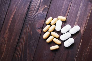 Pills, antidepressants on a dark wooden background