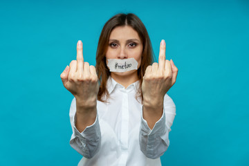 portrait of young woman, hands forward with a gesture fuck you, the mouth is sealed with a white...