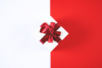 Beautiful present box on red and white background.