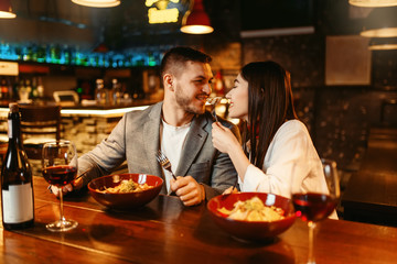 Love couple flirting at wooden bar counter