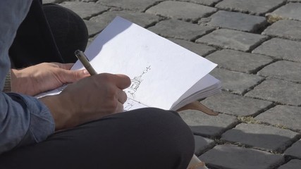 Talented street artist draws a sketch of Papal Basilica of St. Peter cathedral in Piazza San Pietro square of Vatican
