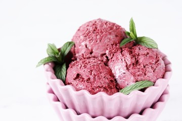 berry ice cream sherbet balls with mint in a beautiful ice-cream bowl. ice cream from  currants, strawberries, raspberries with berries. copy space.