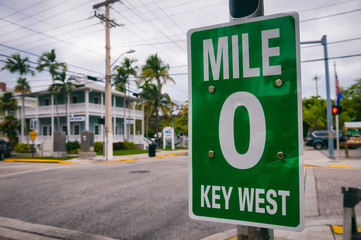 Mile Marker 0 (zero) sign marking the start of US Route 1, the highway that runs on the East Coast from Florida to the Canadian border in Maine in Key West - obrazy, fototapety, plakaty