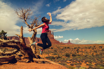 Woman Jumping, Happy Expression. Monument Valley Trip