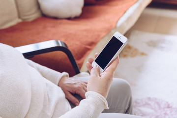 Elderly woman  using a smart Phone.