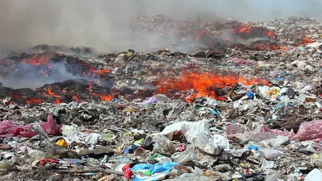 Burning garbage dump pollution, landfill near the city