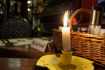 Restaurant reserved table sign with lit candle